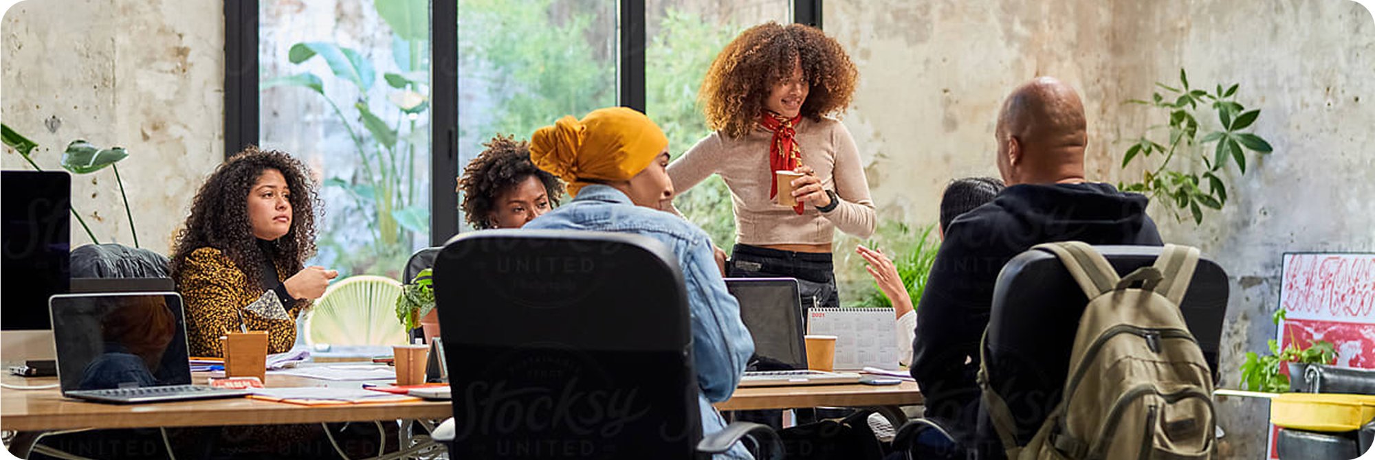 A photograph of a young team working on computers in a modern startup office